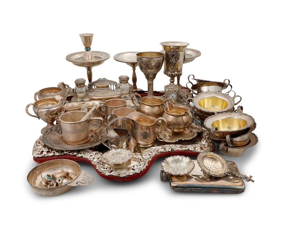 2001 A group of .800 standard and sterling silver articles 19th/20th century Each marked for sterling or .800 silver Comprising ten Shreve & Co. two-handled ramekins, cream and sugars, an inkstand, weighted bowls and vases, an Israeli chalice, a mirror front, and other items  Together with an Abercrombie & Fitch silver-plated flask, an unmarked chalice, an unmarked tray, an unmarked jigger mounted with turquoise, and an unmarked clock case  Mirror: 23" H x 20.5" W x 2.5" D Total weighable sterling: 90.7 gross oz. troy approximately Estimate: $2,000 - $4,000