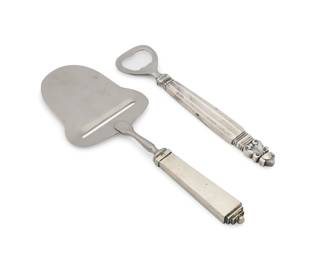 2005 A Georg Jensen sterling silver 'Acorn' bottle opener and 'Pyramid' cheese slicer Circa 1930s With impressed factory marks and: STERLING / DENMARK 2 pieces Bottle opener: 6.375" L; Cheese: 8" L Estimate: $200 - $300