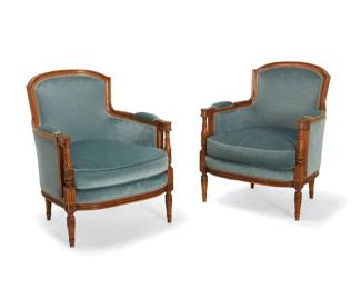 2084 A pair of Louis XVI style carved wood bergères Early 20th century Each with carved acanthus and floral medallion accents to support fronts and armrest terminals, upholstered in a light blue velvet fabric with passementerie trim 2 pieces Each: 33.5" H x 27.5" W x 28" D Estimate: $300 - $500