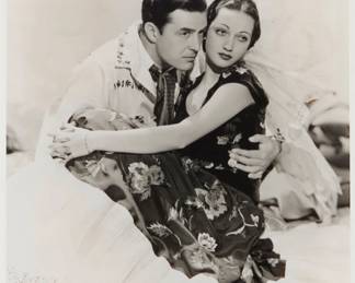 2372 George Hurrell (1904-1992) A portrait of Johnny Mack Brown and Dorothy Lamour Photograph on paper From the edition of unknown size and date Appears unsigned Image: 9.5" H x 7.5" W Estimate: $200 - $300