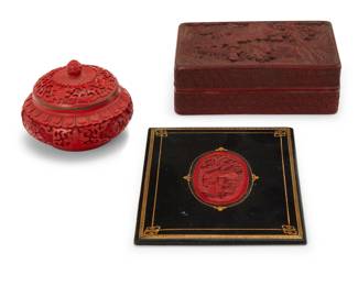 2050 Three Asian cinnabar style items 20th century Comprising a rectangular wood and lacquer lidded box (2.25" H x 6.125" W x 4" D), a round lacquered metal box with enameled interior (2.875" H x 3.875" Dia.), and a lacquer carving set into a leather frame (carving: 3.125" H x 1.875" W; overall: 6.75" H x 5.25" W) 3 pieces Estimate: $200 - $300