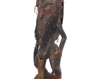 2060 A Papuan carved wood ancestor figure 20th century; likely Sepik River region, Papua New Guinea With cowrie shell eyes and cellulosic fibers to beard and mounted accents 42" H x 15" W x 15" D Estimate: $300 - $500