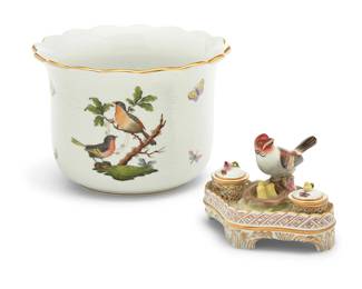 2028 Two Herend porcelain 'Rothschild Bird' articles Late 20th century Each with blue printed factory mark and numbered 7301 or 7800 Comprising a large cachepot and an inkwell 2 pieces Cachepot: 6.375" H x 8.875" Dia.; Inkwell: 4.25" H x 5.75" W x 4.875" D Estimate: $300 - $500