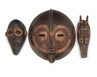 2059 Three African carved wood masks 20th century Comprising a double mouth ceremonial mask from Ghana, a polychrome mask possibly from Ivory Coast, and another mask 3 pieces Largest: 17.5" H x 15.5" W x 5.25" D; Smallest: 12.5" H x 7.875" W x 4" D Estimate: $300 - $500