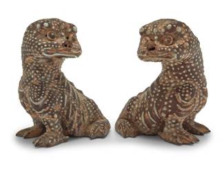 2043 Two Chinese pottery figures of mythical beasts Circa 1900 Each with three-legged toad-like bodies and Qilin heads, decorated with beads of enamel 2 pieces Each: 9" H x 8" W x 7.25" D Estimate: $300 - $500