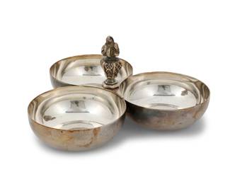 2020 A Christofle silver plated three bowl server Early/mid-20th century With impressed factory marks Centered by a torch finial 4.375" H x 9.125" W x 8.25" D Estimate: $300 - $500