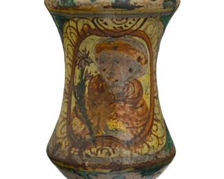 2117 An Italian maiolica albarello 17th/18th century, possibly Sicilian The glazed pottery footed jar possibly depicting Saint Joseph with a lily 9.5" H x 5.375" Dia. Estimate: $400 - $600