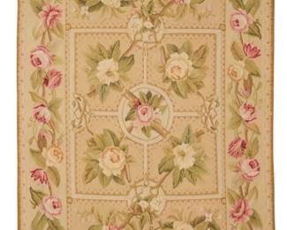 2123 An Aubusson floral area rug Early/mid-20th century A polychrome rectangular flat weave wool needlepoint style tapestry rug featuring a central geometric 'parterre' motif with floral branches and fine geometric edging, surrounded by a twined floral border to all sides 75" H (loom width) x 47.5" W Estimate: $200 - $400