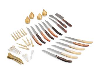 2112 An assorted group of service items Late 20th/early 21st century Knives and cheese servers marked for maker; demitasse spoons with Italian hallmarks: 925 / [star] 176 / FI; brass spoons marked: INDIA; shakers impressed: ARAM Comprising two pairs of Michael Aram gilt-metal garlic-form salt and pepper shakers (2.625" H x 1.875" Dia.), a set of 12 Claude Dozorme stainless steel and resin steak knives in original wood boxes (each knife: 8.625" L; each box: 1.5" H x 10.125" W x 5.75" D), a set of 12 hors d'oeuvre forks (3.375"), 5 hammered brass spoons (4.375") , 3 sterling silver demitasse spoons (3.375"), 2 mother of pearl caviar spoons (2.5"), and a 3-piece cheese serving set (longest: 9") 41 pieces 1 oz. troy approximately Estimate: $300 - $500