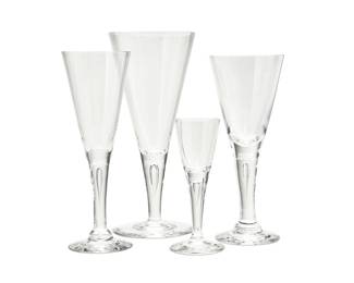 2014 A Steuben glass stemware service Late 20th/early 21st century Each etched: Steuben Each of flared form with narrow teardrops encased in the stems, comprising four 8.5" wine glasses and eight 5" cordial glasses, together with a set of twelve similar Steuben-style 7.75" white wine glasses 24 pieces Estimate: $300 - $500