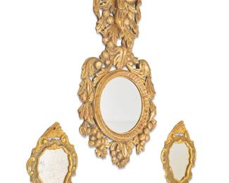 2091 Three giltwood mirrors 20th century Comprising one larger with fruit and foliate motifs and a pair with gilt foliate motifs and edges painted with floral motifs 3 pieces Largest: 31" H x 15.5" W x 1.175" D; Pair: 12.5" H x 8.5" W x 1.75" D Estimate: $200 - $400