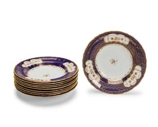 2023 A set of ten A.J. Wilkinson porcelain soup plates Early 20th century Each with red printed factory marks and stamped: Ye olde Hall Potterie / Staffordshire England / 1790; further marked with red painted pattern: 7503; one with retailer's mark for Richard Briggs, Boston; three with faint retailer's mark for Gilman Collamore & Co. Fifth Avenue & 30th, New York Each with cobalt blue rims with gilt circular pattern decoration and polychrome flowers on white ground 10 pieces Each: 9.5" Dia. Estimate: $200 - $300