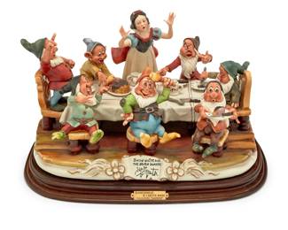 2100 A Laurenz Disney Collection porcelain "Having Dinner, Snow White & The Seven Dwarfs" Modeled 1983 by Enzo Arzenton Edition: 41/2500 With Capodimonte factory stamp to underside, numbered, and inscribed: ART. LZ-53; impressed in scroll at front: SNOW WHITE AND THE SEVEN DWARFS / [signature]; above applied metal plaque reading: BIANCANEVE / E I SETTE NANI / COLLEZIONE "LAURENZ" Overall: 11.25" H x 18.5" W x 12.75" D Estimate: $400 - $600