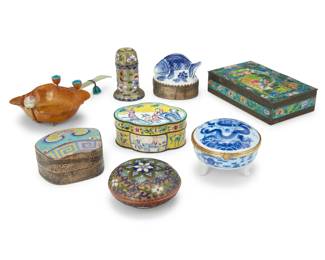 2037 A group of eight Chinese porcelain and enamel boxes 20th century One porcelain with maker's marks and: MADE IN CHINA Comprising five enameled metal boxes and two blue and white porcelain and metal boxes, each with mirror mounted to lid underside, together with an enamel brush cleaner with green hardstone handle 8 pieces Largest box: 1.5" H x 6" W x 3.75" D; Porcelain fish: 2.5" H x 3" W x 2" D Estimate: $300 - $500