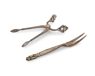 2006 A Georg Jensen sterling silver 'Acorn' sugar tongs and a date fork Circa 1930s Introduced 1915 With impressed factory marks and: STERLING / DENMARK Housed in a fitted box 2 pieces Tongs: 4.125" L; Date fork: 4.625" L; Box: 1.25" H x 6" W x 4" D Total weight: 1.2 oz. troy approximately Estimate: $200 - $300