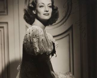 2343 George Hurrell (1904-1992) A portrait Joan Crawford Photograph on paper From the edition of unknown size and date Signed and inscribed, presumably, by the sitter upper right: "Sue Harris / Gratefully / Joan Crawford" Image: 12" H x 9.25" W Estimate: $200 - $300