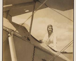 2398 Wendell MacRae (1896-1980) "Ms. Seversky's First Solo [Flight]," circa 1931 Photograph in sepia on paper Signed in pencil on the mount directly below the image, at right: Wendell McRae [sic]; titled in pencil on the mount, possibly in another hand; inscribed in pencil with the artist's 1980 copyright, and numbered "W-80-238," also inscribed in pencil: "Wife of Major Alexander Seversky, airplane / designer and noted flier, after landing / following her first solo flight 1931? / at Long Island aviation / Country Club.," all in pencil, and some or all possibly in another hand, verso. Image/Sheet: 10" H x 7" W; Sight: 10.5" H x 7.5" W Estimate: $400 - $600