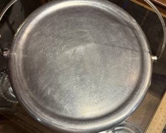 Cast aluminum griddle with handle. https://modestlambestatesales.hibid.com/