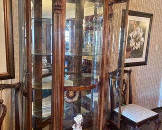 Pulaski bowed front curve glass empire style curio with illuminated interior, 4 adjustable glass shelves with dentilled molding and detailed carved claw feet