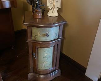 Petite antique green and brown cabinet with feather vine motif