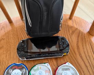 Black Sony PSP handheld console, UMD Sin City, UMD Tiger Woods PGA Tour 2006