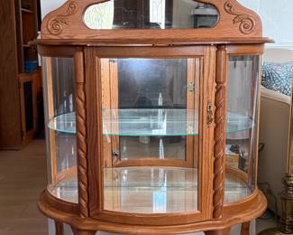 Lighted oak bow-front cabinet