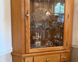 1 of 2 matching lighted corner cabinets