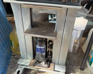 homemade hydraulic shop press, constructed using a steel frame and a Kobalt brand bottle jack