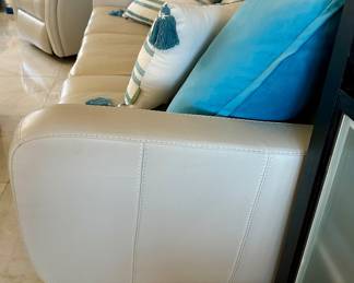 The solid teal pillow on the sofa were sold.