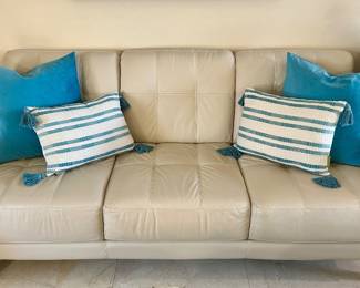 The solid teal pillows on the sofa were sold.
