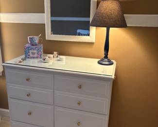 8 drawer dresser with brass pulls and with a protective glass top, mirror and navy lamp