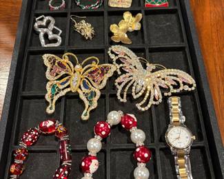 Holiday accessories, along with Timex watch and two large butterfly pins
