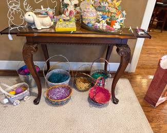 Side table with glass, top drawers, and extensions shown with Easter baskets and decor