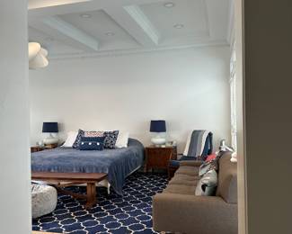 This image is for staging purposes only to showcase the rug, bench, couch, and white lamps.