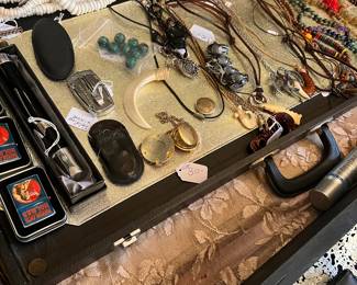 Sample of objects we are selling in one of four cases: necklaces, ...ccollectable lighters...