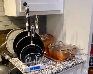 Lots of pots and pans as well as numerous kitchen staples