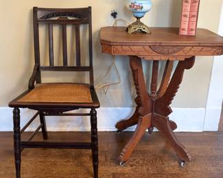 Beautiful Victorian hurricane parlor lamp in blue milk glass base and globe with hand painted floral motifs. Great Victorian Eastlake parlor table with carved inlays. Vintage chair from Eastlake or Victorian style