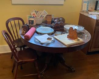 Antique round kitchen table with claw feet, two small kitchen chairs and a variety of vintage items