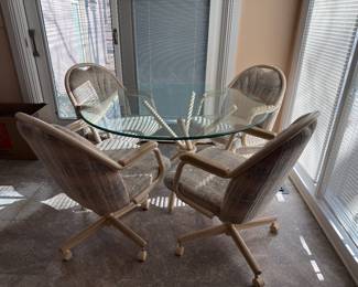 	#24	Glass Top Table with 4 Rolling Chairs 48x28	 $150.00 				