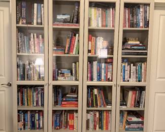 One of multiple bookcases. Many books - hardcover, softcover, fiction, non-fiction.