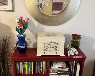 Large round mirror, red bookcase, jewelry chest 