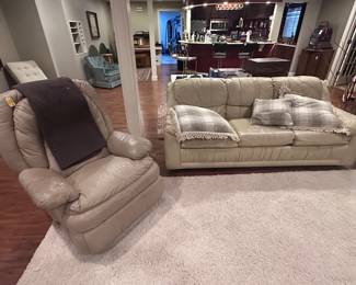 Leather rocker, leather couch, white large area rug,