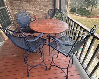 Navy wrought iron bar height stools with wood top tall table