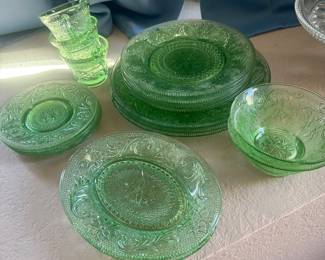 green Depression glass in the Cherry Blossom pattern made by the Jeannette Glass Company.