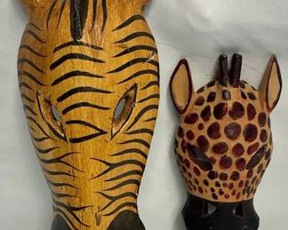 set of handcarved wooden African safarithemed masks, featuring a zebra and a giraffe