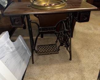 Repurposed cast iron Singer sewing machine base table with brass bowl insert.