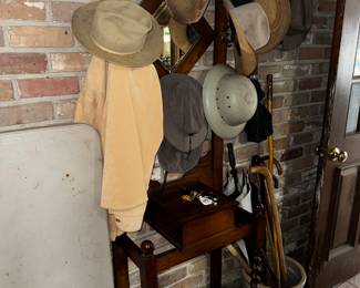 Wooden hall tree, hats and canes.