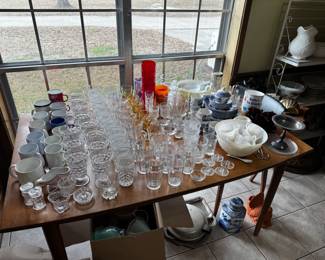 Table full of glassware, including American Fostoria.