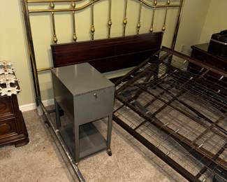 King sized brass headboard with frame. Also rolling trundle bed frame