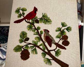 Red bird needle point on stretched canvas and mounted on board.